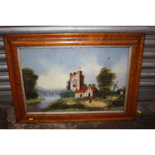 24 - A SATINWOOD FRAMED REVERSE PAINTING ON GLASS DEPICTING A CHURCH BESIDE A RIVER A/F - SIZE 60CM X 41C... 