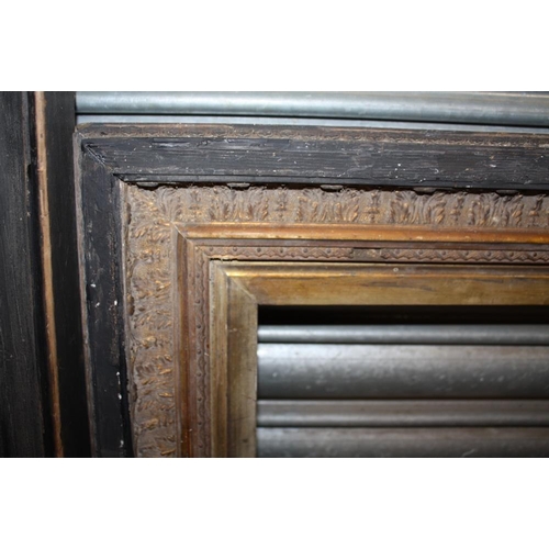 32 - TWO GILT AND EBONISED WOODEN PICTURE FRAMES - LARGEST REBATE SIZE 65.5CM X 49CM - SMALLEST REBATE 51... 