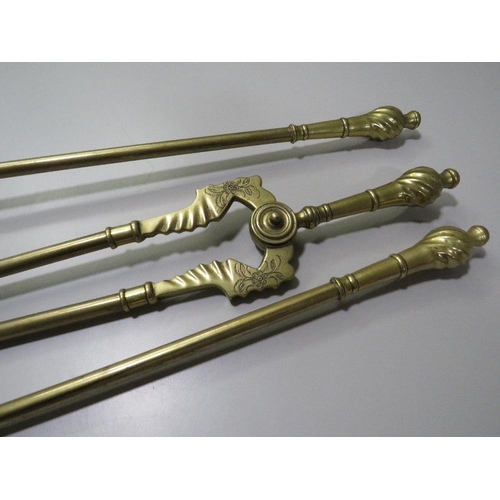 250 - A VINTAGE BRASS THREE PIECE FIRESIDE COMPANION SET