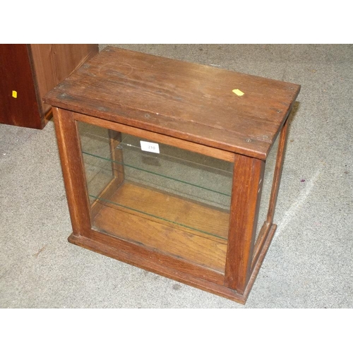 210 - A FOUR SIDED GLAZED OAK DISPLAY CABINET, H 41 CM, W 45.5 CM, D 25 CM