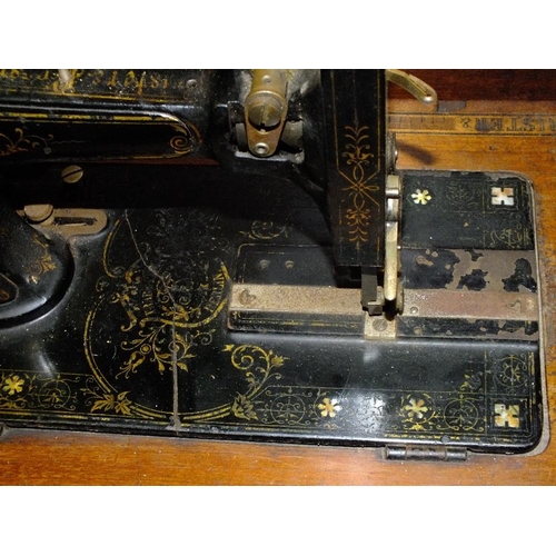 211 - AN INLAID MAHOGANY CASED ANTIQUE FRISTER AND ROSSMANN SEWING MACHINE