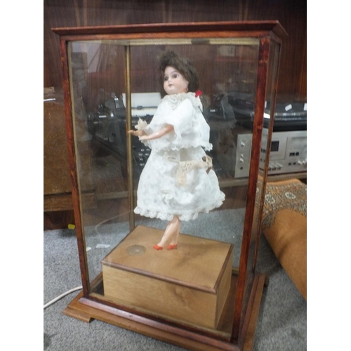 233 - A GLASS CASED MUSICAL REVOLVING DOLL