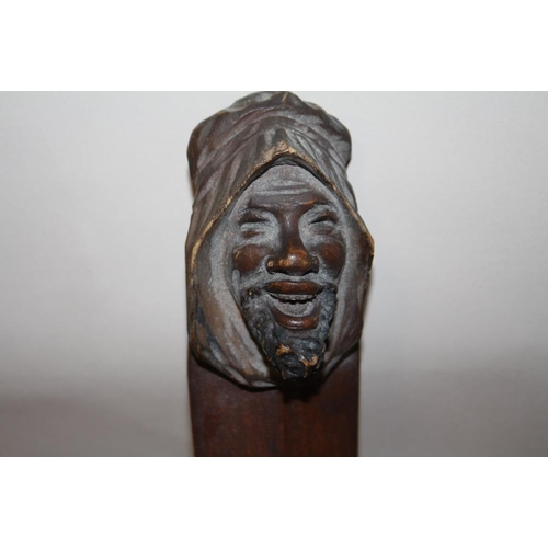 385 - A BLACK FOREST STYLE CARVER WOODEN PAGE TURNER IN THE FORM OF A GENTLEMAN