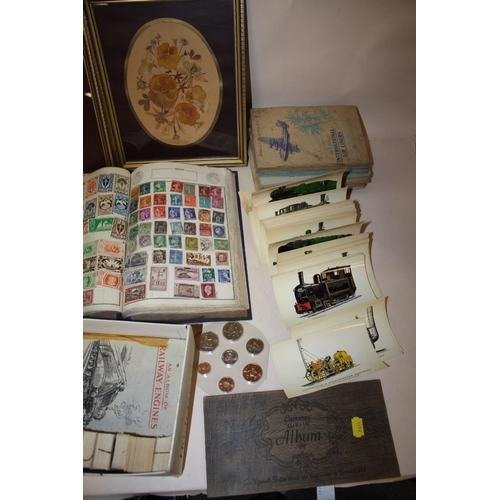 397 - A QUANTITY OF CIGARETTE CARDS BOTH LOOSE AND IN ALBUMS TOGETHER WITH A WORLD STAMP ALBUM, POSTCARDS ... 
