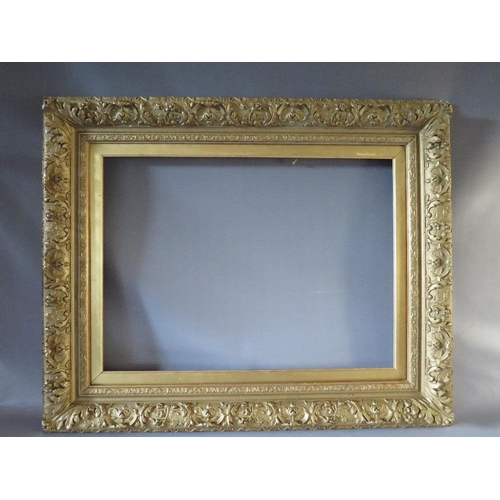 49 - A 19TH CENTURY GOLD DECORATIVE FRAME WITH GOLD SLIP, frame W 12 cm, slip rebate 77 x 57 cm, frame re... 