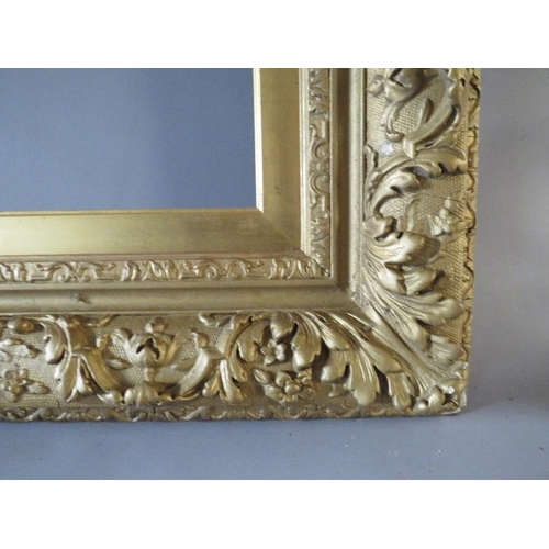 49 - A 19TH CENTURY GOLD DECORATIVE FRAME WITH GOLD SLIP, frame W 12 cm, slip rebate 77 x 57 cm, frame re... 