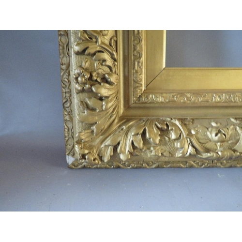 49 - A 19TH CENTURY GOLD DECORATIVE FRAME WITH GOLD SLIP, frame W 12 cm, slip rebate 77 x 57 cm, frame re... 