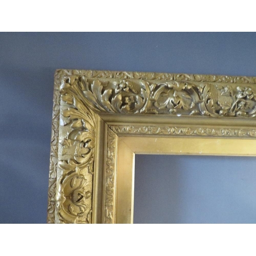 49 - A 19TH CENTURY GOLD DECORATIVE FRAME WITH GOLD SLIP, frame W 12 cm, slip rebate 77 x 57 cm, frame re... 