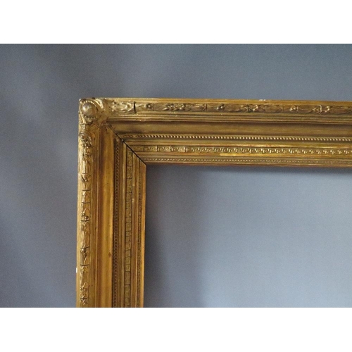 52 - A 19TH CENTURY GOLD FRAME WITH ACANTHUS LEAF DESIGN TO OUTER EDGE, frame W 10 cm, frame rebate 85.5 ... 