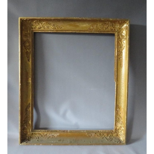 56 - AN 18TH CENTURY FRENCH DECORATIVE GOLD FRAME WITH INTEGRAL SLIP, frame W 8 cm, frame rebate 66 x 55 ... 