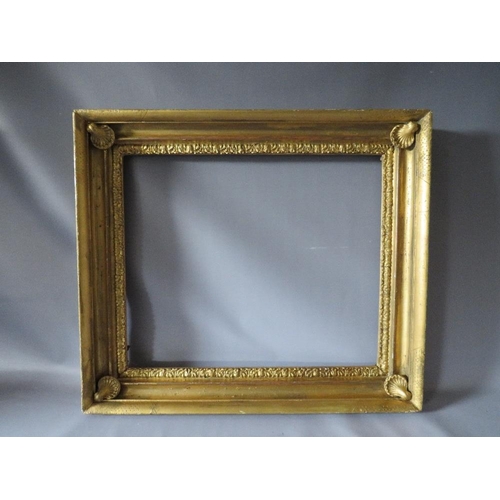 57 - AN 18TH CENTURY GOLD FRAME WITH SHELL EMBELLISHMENTS TO INNER CORNERS, frame W 7 cm, frame rebate 59... 