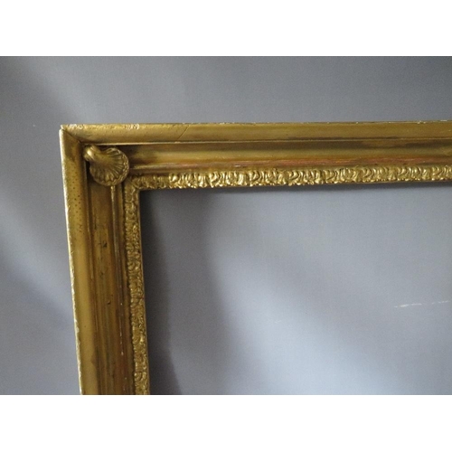 57 - AN 18TH CENTURY GOLD FRAME WITH SHELL EMBELLISHMENTS TO INNER CORNERS, frame W 7 cm, frame rebate 59... 