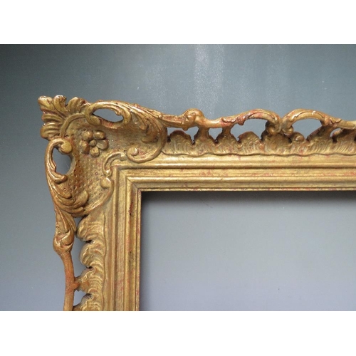 64 - AN EARLY 20TH CENTURY CHIPPENDALE STYLE GOLD PIERCED FRAME, frame W 9 cm, frame rebate 52 x 31.5 cmC... 