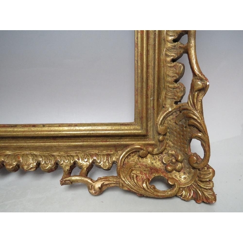 64 - AN EARLY 20TH CENTURY CHIPPENDALE STYLE GOLD PIERCED FRAME, frame W 9 cm, frame rebate 52 x 31.5 cmC... 