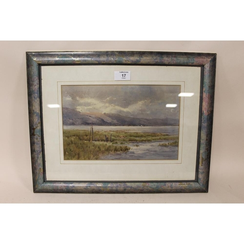 17 - A FRAMED AND GLAZED WATERCOLOUR DEPICTING A MOUNTAINOUS RIVER LANDSCAPE WITH SHEEP GRAZING SIGNED J.... 