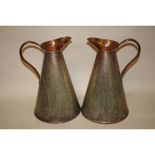 215 - A PAIR OF ARTS AND CRAFTS STYLE HAMMERED FINISH COPPER JUGS, H 37 CM