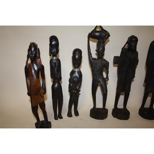 223 - A COLLECTION OF EIGHT ASSORTED CARVED WOODEN TRIBAL STYLE FIGURES