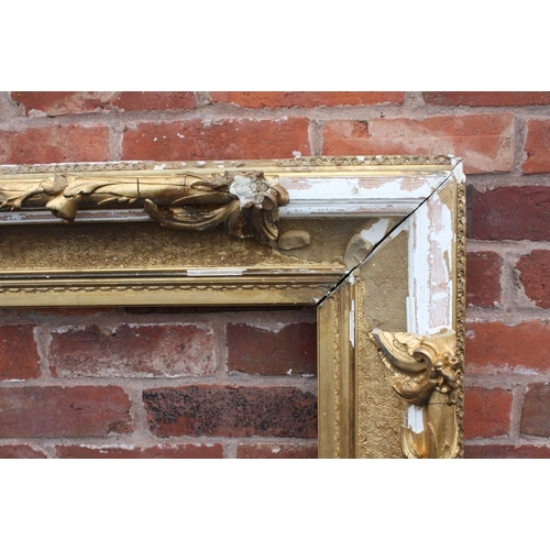52 - A LARGE 19TH CENTURY GOLD DECORATIVE SWEPT FRAME - WITH DAMAGES, frame W 17 cm, rebate 120 x 97 cm