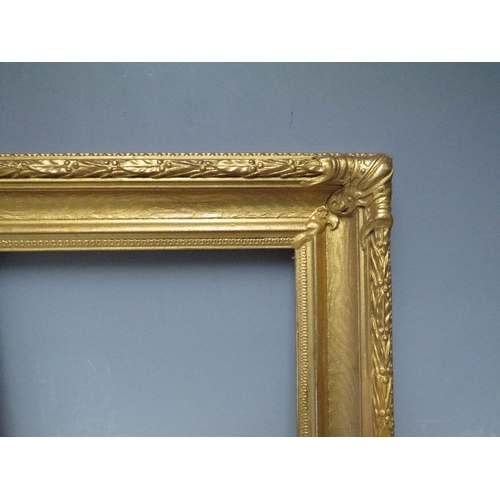 62 - A 19TH CENTURY DECORATIVE GOLD FRAME, with acanthus leaf design to edges and corner embellishments, ... 