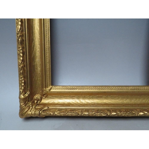 62 - A 19TH CENTURY DECORATIVE GOLD FRAME, with acanthus leaf design to edges and corner embellishments, ... 