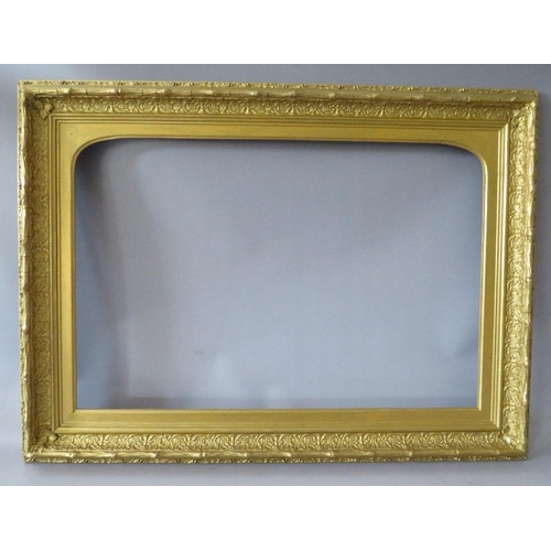 63 - A 19TH CENTURY DECORATIVE GOLD FRAME, with arched top integral slip, some restoration, frame W 8 cm,... 