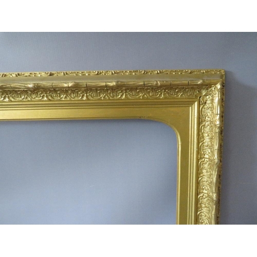 63 - A 19TH CENTURY DECORATIVE GOLD FRAME, with arched top integral slip, some restoration, frame W 8 cm,... 