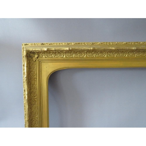 63 - A 19TH CENTURY DECORATIVE GOLD FRAME, with arched top integral slip, some restoration, frame W 8 cm,... 