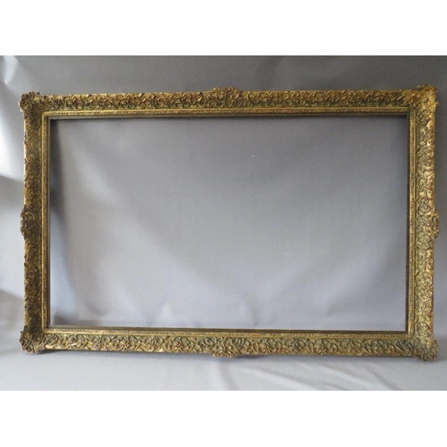 75 - A LATE 19TH / EARLY 20TH CENTURY DECORATIVE GOLD FRAME WITH WOODEN SLIP, frame W 7 cm, slip rebate 1... 