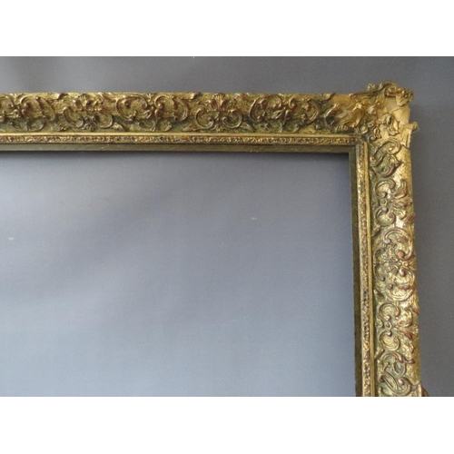 75 - A LATE 19TH / EARLY 20TH CENTURY DECORATIVE GOLD FRAME WITH WOODEN SLIP, frame W 7 cm, slip rebate 1... 
