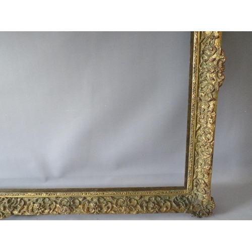75 - A LATE 19TH / EARLY 20TH CENTURY DECORATIVE GOLD FRAME WITH WOODEN SLIP, frame W 7 cm, slip rebate 1... 