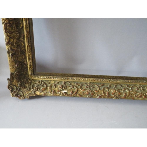 75 - A LATE 19TH / EARLY 20TH CENTURY DECORATIVE GOLD FRAME WITH WOODEN SLIP, frame W 7 cm, slip rebate 1... 