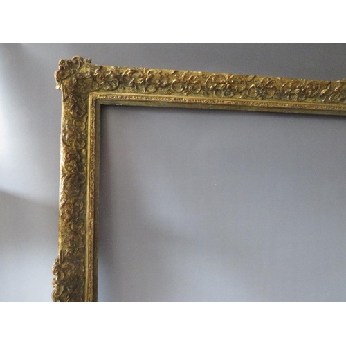 75 - A LATE 19TH / EARLY 20TH CENTURY DECORATIVE GOLD FRAME WITH WOODEN SLIP, frame W 7 cm, slip rebate 1... 