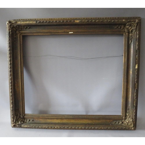 77 - A 19TH CENTURY DECORATIVE GOLD FRAME WITH CORNER EMBELLISHMENTS, frame W 10 cm, rebate 56 x 69 cm