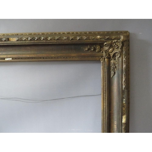 77 - A 19TH CENTURY DECORATIVE GOLD FRAME WITH CORNER EMBELLISHMENTS, frame W 10 cm, rebate 56 x 69 cm