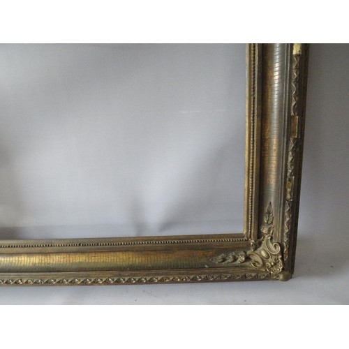 77 - A 19TH CENTURY DECORATIVE GOLD FRAME WITH CORNER EMBELLISHMENTS, frame W 10 cm, rebate 56 x 69 cm