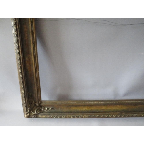 77 - A 19TH CENTURY DECORATIVE GOLD FRAME WITH CORNER EMBELLISHMENTS, frame W 10 cm, rebate 56 x 69 cm