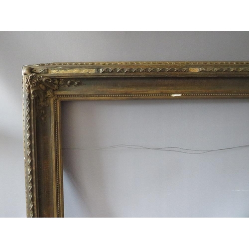 77 - A 19TH CENTURY DECORATIVE GOLD FRAME WITH CORNER EMBELLISHMENTS, frame W 10 cm, rebate 56 x 69 cm