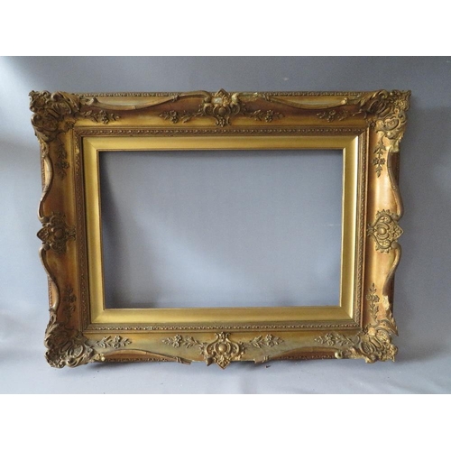 78 - A 19TH CENTURY DECORATIVE GOLD SWEPT FRAME WITH GOLD SLIP, frame W 10 cm, slip rebate 61 x 41 cm, fr... 