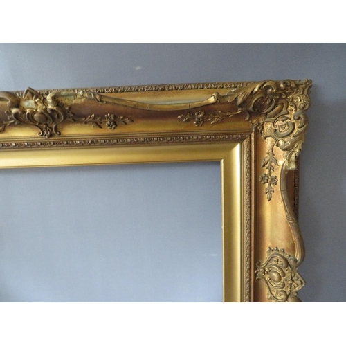 78 - A 19TH CENTURY DECORATIVE GOLD SWEPT FRAME WITH GOLD SLIP, frame W 10 cm, slip rebate 61 x 41 cm, fr... 