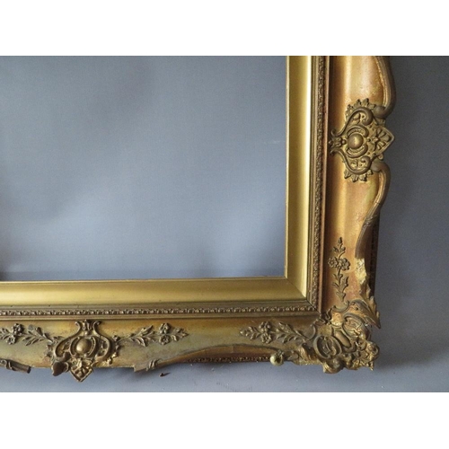 78 - A 19TH CENTURY DECORATIVE GOLD SWEPT FRAME WITH GOLD SLIP, frame W 10 cm, slip rebate 61 x 41 cm, fr... 