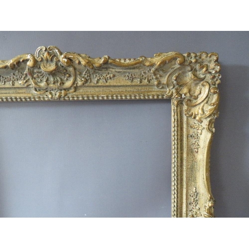 82 - A PAIR OF 20TH CENTURY DECORATIVE GILT SWEPT FRAMES, frame W 7 cm, rebate 51 x 39 cm