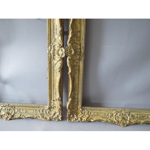 82 - A PAIR OF 20TH CENTURY DECORATIVE GILT SWEPT FRAMES, frame W 7 cm, rebate 51 x 39 cm