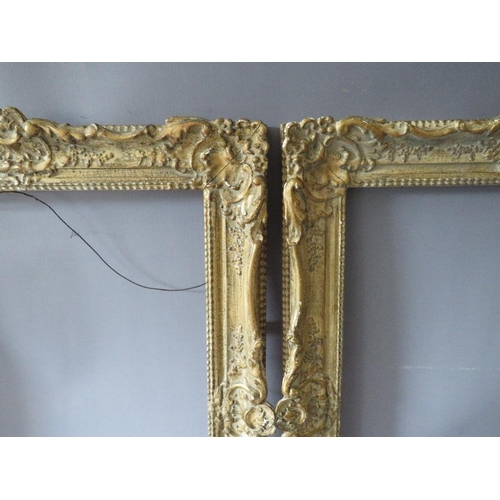 82 - A PAIR OF 20TH CENTURY DECORATIVE GILT SWEPT FRAMES, frame W 7 cm, rebate 51 x 39 cm