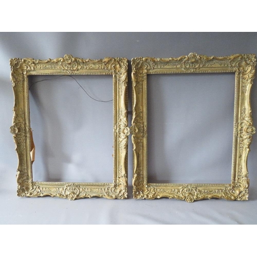 82 - A PAIR OF 20TH CENTURY DECORATIVE GILT SWEPT FRAMES, frame W 7 cm, rebate 51 x 39 cm