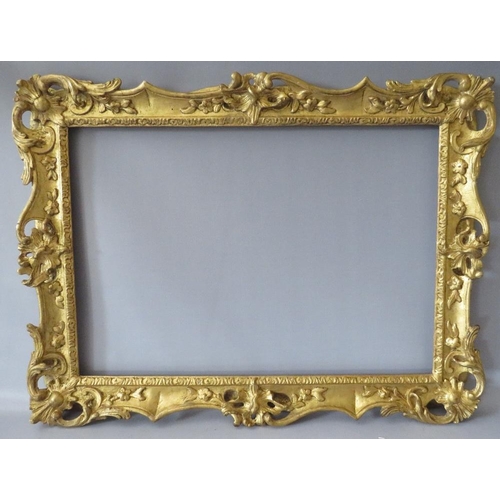 84 - A 19TH CENTURY CARVED WOODEN DECORATIVE GILT SWEPT FRAME, frame W 7 cm, rebate 58 x 42 cm