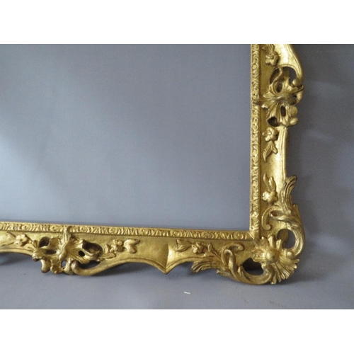 84 - A 19TH CENTURY CARVED WOODEN DECORATIVE GILT SWEPT FRAME, frame W 7 cm, rebate 58 x 42 cm