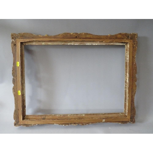 84 - A 19TH CENTURY CARVED WOODEN DECORATIVE GILT SWEPT FRAME, frame W 7 cm, rebate 58 x 42 cm