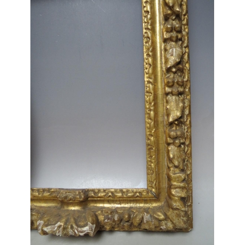 91 - A 17TH CENTURY CONTINENTAL DECORATIVE CARVED WOODEN FRAME WITH ARCHED TOP, frame W 7 cm, rebate 40 x... 