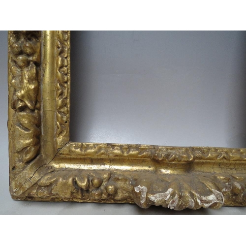 91 - A 17TH CENTURY CONTINENTAL DECORATIVE CARVED WOODEN FRAME WITH ARCHED TOP, frame W 7 cm, rebate 40 x... 