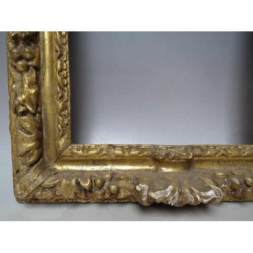 91 - A 17TH CENTURY CONTINENTAL DECORATIVE CARVED WOODEN FRAME WITH ARCHED TOP, frame W 7 cm, rebate 40 x... 